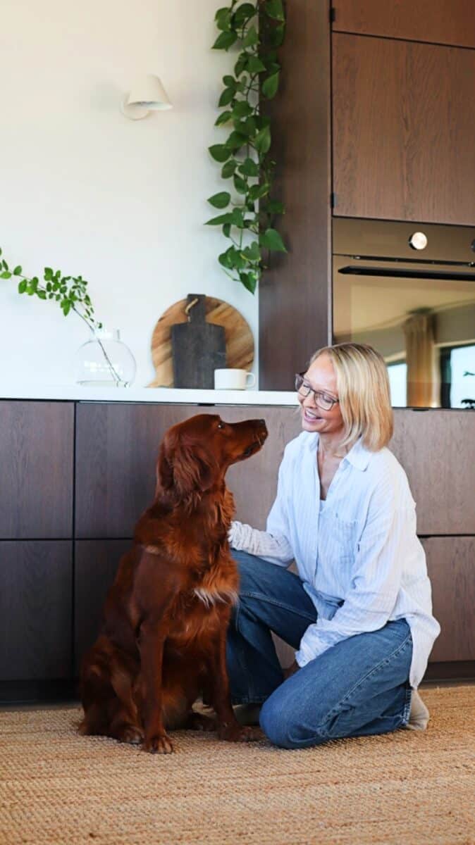 kvinna sitter med hund kok